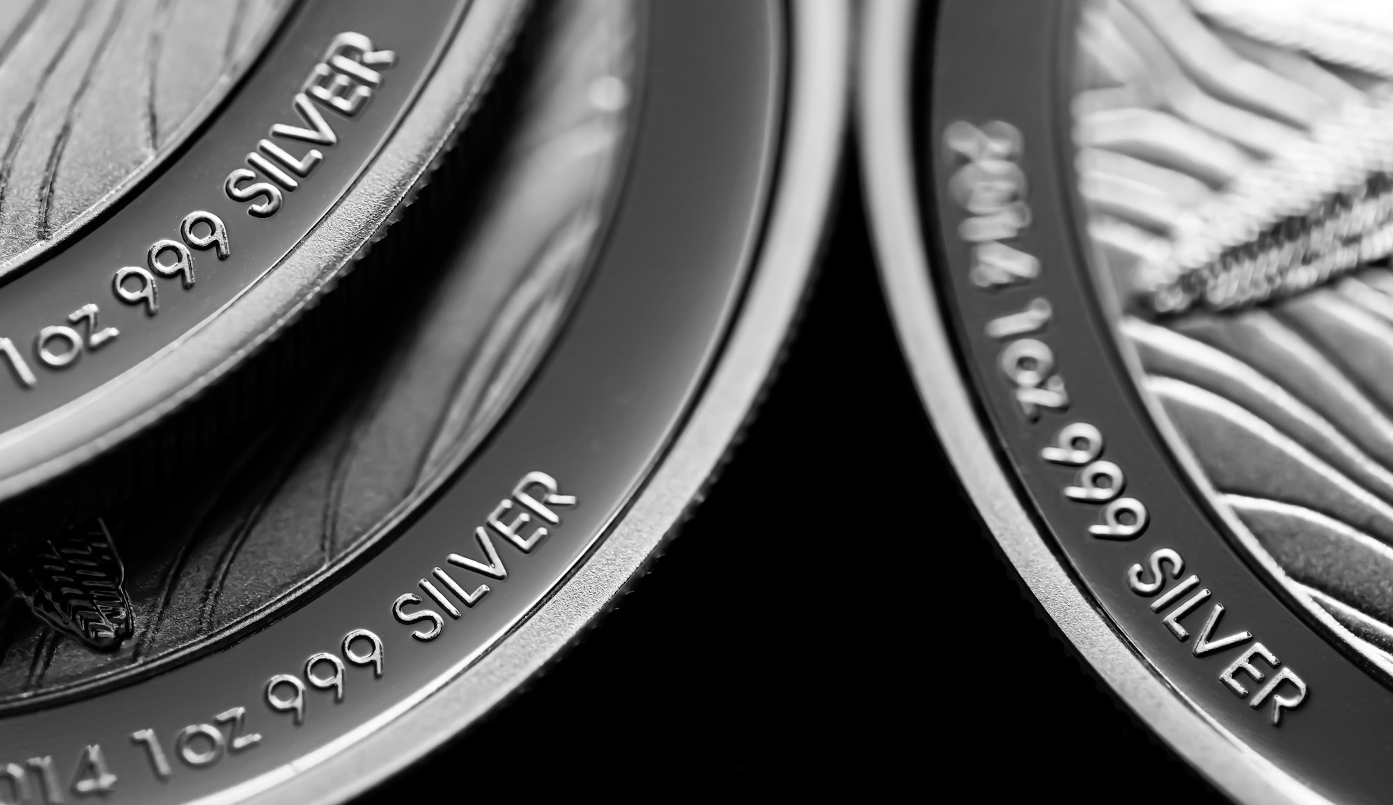 Close up of Silver Bullion Coin on a black mirror background